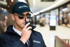 Safety Host Unit security officer communicating via radio during active protection detail in WestLos Angeles