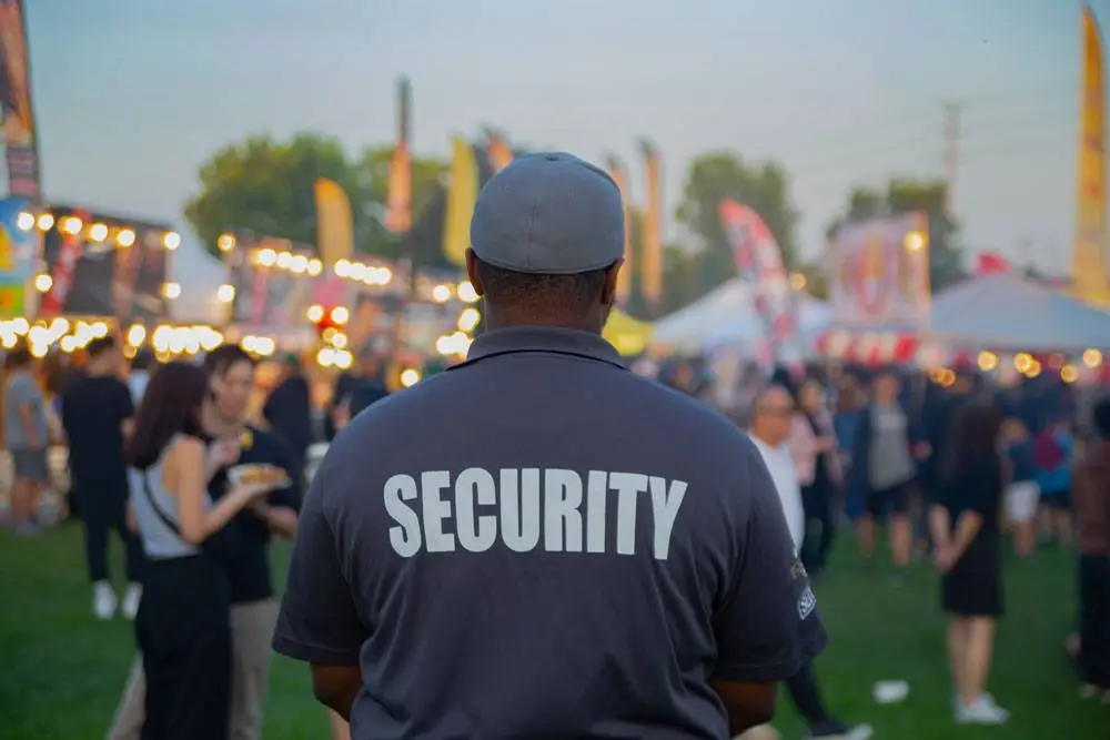 Professional event security guard monitoring crowd at a large public event in Los Angeles